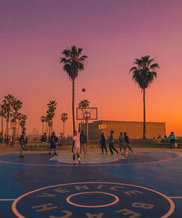 Students at USIU basketball court under sunset lights